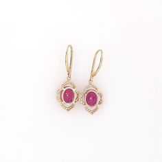 These beautiful dangle earrings feature a pair of 7.28 carat weight Ruby gemstones with natural earth mined diamonds and milgrain detail, all set in solid 14K gold. These Ruby dangles make a lovely July birthstone gift for your loved ones! These earrings are made with solid 14k Gold and natural earth mined SI / G-H Diamonds. As listed, these earrings are ready to ship. If you're interested in purchasing this setting with a different center stone please message us! Jewelry Appraisal, Jewelry Safe, July Birthstone, Ruby Gemstone, Custom Jewelry Design, Natural Earth, Diamond Clarity, Birthstone, Ruby