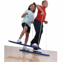 two children on skis with poles in their hands and one child standing on the board