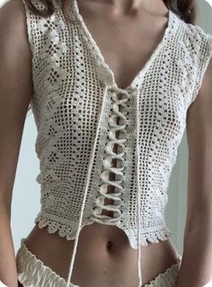 a woman wearing a white crochet top and panties