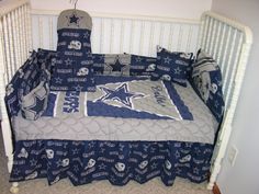 this is a crib bedding set with the cowboys logo on it and skulls