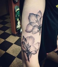 a woman with a flower tattoo on her arm