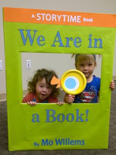 two children holding up a book with the title we are in a book