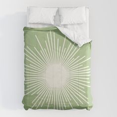 a green and white comforter with sunbursts on it's side