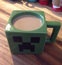 a cup of coffee sitting on top of a wooden table