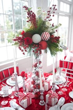 a christmas centerpiece with red and white decorations