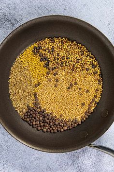 yellow and brown lentils in a frying pan