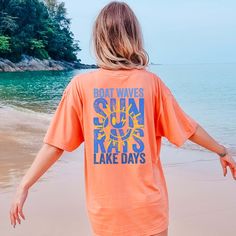 Hey there, sunshine! Are you ready to bask in the warmth of sun rays and embrace the joy of lake days? The "Sun Rays Lake Days Blue Back Design" Comfort Color Tee is the perfect blend of sunshine and lakeside charm, now with a stylish back design! Crafted from premium Comfort Color fabric, this tee feels as soft and comforting as a gentle summer breeze. The vibrant "Sun Rays Lake Days Blue Back Design" graphic on the back celebrates the beauty of sunny days and lakeside adventures. Whether you'r Summer Outdoor Top With Letter Print, Summer Outdoor Tops With Letter Print, Summer Tops With Letter Print For Outdoor, Beach Tops With Sun Protection And Short Sleeves, Short Sleeve Tops With Upf 50+ For Beach, Upf 50+ Short Sleeve Tops For Beach, Summer Tops With Upf 50+ For Beach Season, Crew Neck Top For Beach Season, Crew Neck Tops For Beach Season Warm Weather