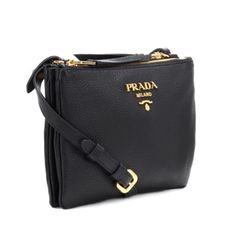 This cute and practical everyday crossbody Prada bag is the perfect accessory to add luxury to any everyday outfit. The double zipper with a center compartment dividing the two zipper pockets give the added feature of tons of space in a small compact crossbody style bag. The color of this bag is beautiful and classic, which makes this the perfect neutral bag for your handbag collection.      Model: 1BH046  Black Vitello Phenix Leather  Adjustable and Detachable crossbody strap  Gold-tone hardwar Evening Crossbody Bag With Metal Zipper, Travel Crossbody Bag With Metal Zipper, Everyday Crossbody Bag With Metal Zipper, Luxury Crossbody Bag With Metal Zipper, Prada Cross Body Bag, Black Prada Crossbody Bag, Luxury Crossbody Bag Strap With Gold-tone Hardware, Prada Black Shoulder Bag, Luxury Gold-tone Hardware Crossbody Camera Bag