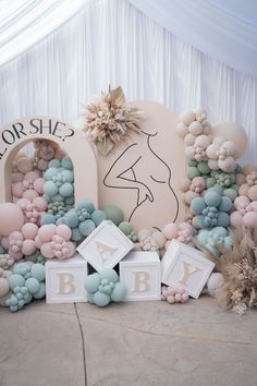 there is a backdrop made out of balloons and letters that spell out the word baby