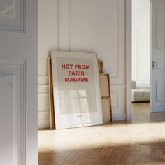 there is a sign that says not from paris madame in red on the floor