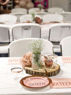 the table is set with plates and vases for guests to sit on, along with napkins