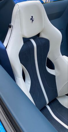 the interior of a blue and white sports car