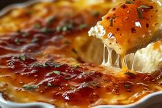 a piece of lasagna being lifted with a fork from a casserole dish