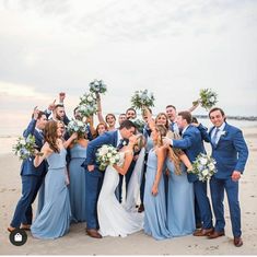 a group of people standing next to each other on a beach