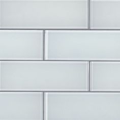 a close up view of a white tile wall