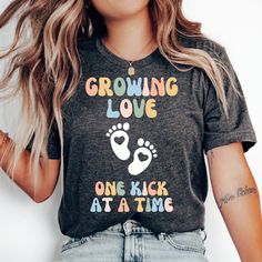 Growing Love One Kick at a Time T-shirt, Funny Pregnancy Shirt, Pregnancy Announcement, Baby Shower Shirt, Expecting Mom, Pregnant Shirt * Bella + Canvas 3001 Unisex T-shirt * 100% combed and ring-spun cotton (Heather colors contain polyester) * Pre-shrunk fabric * Feels soft and lightweight * Fits true to size HOW TO ORDER 1. Select your desired size, color and quantity from the drop-down menus. 2. Click "Add to Cart" and proceed to checkout. SIZING Please see the size chart image for specific measurements. RETURNS Given the personalized nature of our made-to-order products, we are unable to accommodate returns or exchanges. CARE INSTRUCTIONS * Machine wash cold inside out with like colors * Tumble dry low or hang dry for best results * Avoid ironing directly on the design to preserve its Cute Maternity T-shirt With Letter Print, Cute Maternity T-shirt With Graphic Print, Cute Maternity Graphic Print T-shirt, Maternity Casual T-shirt With Funny Print, Casual Maternity T-shirt With Funny Print, Cute Maternity Cotton T-shirt, Casual Maternity T-shirt With Funny Text, Maternity Graphic Tee With Short Sleeve, Maternity Family Matching T-shirt With Graphic Print