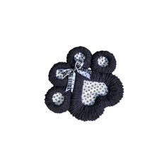 two black and white crocheted flowers with polka dots on the petals, one in the