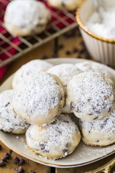 snowball cookies on a plate with chocolate chips around it and the title overlay reads, snowball cookies christmas recipes