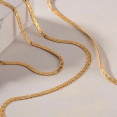 Elevate your everyday look with our Textured Herringbone Necklace. This essential layering piece features a classic herringbone chain with a unique textured design. Versatile and stylish, it's the perfect addition to any outfit. Size: 16" with a 2" extension chain attached Material: Stainless Steel Plating: 18k real gold Necklace is 100% nickel-free and cadmium-free Necklace is hypoallergenic and tarnish resistant Elegant Luxury Yellow Gold Herringbone Necklace, Luxury Yellow Gold Herringbone Necklace, Trendy Herringbone Necklace With Snake Chain, Trendy Herringbone Clavicle Necklace With Snake Chain, Trendy Metal Herringbone Necklace As Gift, Real Gold Necklace, Herringbone Chain, Herringbone Necklace, Small Boutique