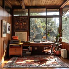 a home office with wood paneling and large windows overlooking the trees in the forest