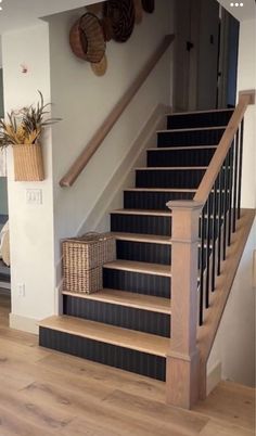 there is a set of stairs with baskets on the bottom one and another handrail