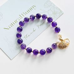 Unleash the power of positivity with our handmade Amethyst Pearl Beaded Bracelet! Amethyst is known for its ability to provide spiritual protection and purification, clearing one's energy field of any negative influences and attachments. The beautiful purple crystal beads help promote balance and inner peace, while the shell with an imitation pearl charm adds a touch of elegance. Plus, the two freshwater pearls enhance its timeless beauty and calming energy. Elevate your style and energy with th Spiritual Protection, Power Of Positivity, Purple Crystal, Energy Field, Pearl Charms, Purple Crystals, Inner Peace, Pearl Beads, Beaded Bracelet