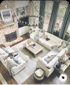 a living room filled with furniture and a fire place in the middle of a room