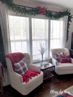 the living room is decorated for christmas with red and white plaid pillows on the couches