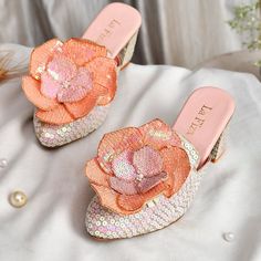 Step into elegance with these Ethnic White Floral Block Heels, a perfect fusion of artisanal craftsmanship and contemporary style. Designed with a striking large floral applique on each shoe, these heels are meticulously handcrafted to add a unique and luxurious touch to your special occasions. The flower applique, in vibrant shades of peach and pink sequins, is detailed with delicate pearls, giving these shoes an eye-catching appeal that's both festive and feminine. The heel and base are adorne Christmas Heels, Women's Party Wear, Indian Shoes, Embroidered Heels, Shades Of Peach, Bridal Event, Womens Wedding Shoes, Flower Applique, Floral Applique