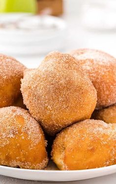 a white plate topped with sugar covered donuts