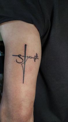 a person with a tattoo on their arm that reads, strength and is holding a knife