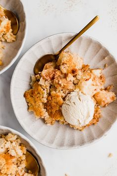 three bowls filled with food on top of a white table