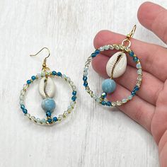 These gorgeously sparkly, beaded hoop earrings are handmade by me for your next beach trip!  The gold hoops are wire wrapped in Czech glass beads of all the colors of the ocean.  I've added cowrie shells and a gemstone bead that I can't remember the name of 🤣but the light blue color looks great with the other beads!  They are very lightweight as well.  The fish hook earwires are  nickel free Beach Earrings, Jewelry Blue, Ocean Inspired, Shell Jewelry, Cowrie Shell