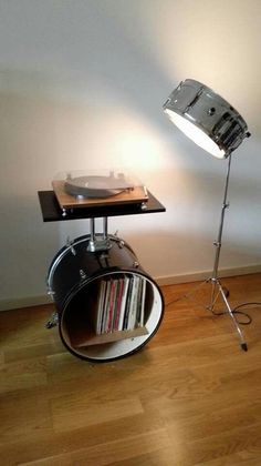 a record player is sitting on top of a table next to a turntable and lamp