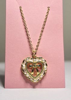 pink heart bow necklace  cute & dainty coquette style necklace  14k gold plated necklace 18, 20, & 24 inches  pendant is approximately 1inchx.75inch by purchasing from Kristen's Kollection's the customer agrees that the use of the jewelry is entirely at the customer's own risk. Warning: jewelry may be a choking hazard, please keep away from children. Final sale. Heart Necklace Princess, Luxury Romantic Heart-shaped Necklace, Luxury Heart-shaped Romantic Necklace, Cheap Rose Gold Heart Charm Necklaces, Affordable Romantic Heart Necklace For Valentine's Day, Cheap Romantic Heart Necklace For Valentine's Day, Affordable Heart Charm Pendant Necklace, Affordable Heart Necklace For Valentine's Day, Cheap Heart Charm Necklace For Valentine's Day