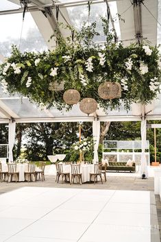 the inside of a tent with tables and chairs set up for an outdoor wedding reception