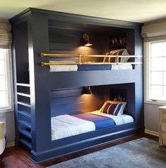 the bunk bed is built into the side of the wall and has two lights on it