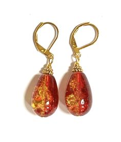 Amber glass gold plated brass lever back teardrop shaped earrings. The earrings are dark red on one side and golden yellow semi-opaque on the other side. Multiple little bubbles inside the amber-tone glass reflect light and make it shine from within.  Dimensions: Total length: 1.5 inches (38 mm) Width (in the widest part): 0.47 inches (12 mm)  TO VIEW MY ENTIRE SHOP: https://www.etsy.com/shop/Voleena Gold Teardrop Glass Earrings, Gold Teardrop Czech Glass Earrings, Easy Jewelry, Teardrop Dangle Earrings, Red Orange Yellow, Amber Glass, Golden Yellow, Orange Yellow, Earrings Handmade