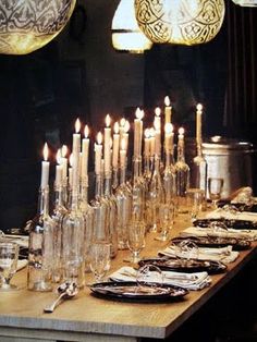 a long table with candles and plates on it