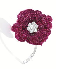 18 Karat Gold, Platinum, Invisibly-Set Ruby and Diamond Flower Brooch, Oscar Heyman & Brothers. Of floral design, the petals set with numerous invisibly-set rubies weighing approximately 109.80 carats, centering round diamonds weighing 3.88 carats, the stem set with baguette and trapeze-cut diamonds weighing 1.55 carats. Diamond Flower Brooch, Jewelry Pics, Jewelry Luxury, Expensive Jewelry, Diamond Flower