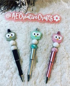 three pens with owls on them sitting next to a sign that says af creative crafts