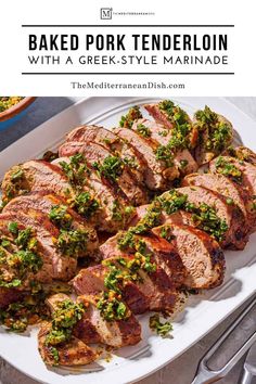 baked pork tenderloin with greek - style marinade on a white platter