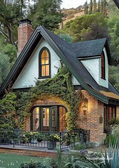 the house is surrounded by greenery and trees