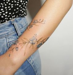 a woman with a flower tattoo on her arm