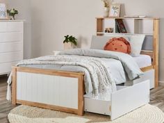 a white bed with two drawers underneath it