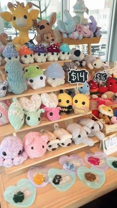 there are many small stuffed animals on the shelves in this store, and one is for sale