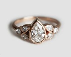 an engagement ring with three pear shaped diamonds