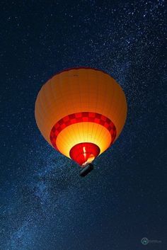 a hot air balloon flying through the night sky