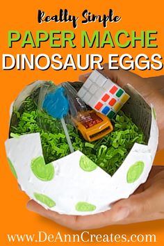 Really Simple Paper Mache Dinosaur Eggs Tutorial.  The picture shows a pair of hands holding a paper mache dinosaur egg filled with crinkle paper and party favors.