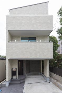 an apartment building with a parking meter in front of it and stairs leading up to the second floor